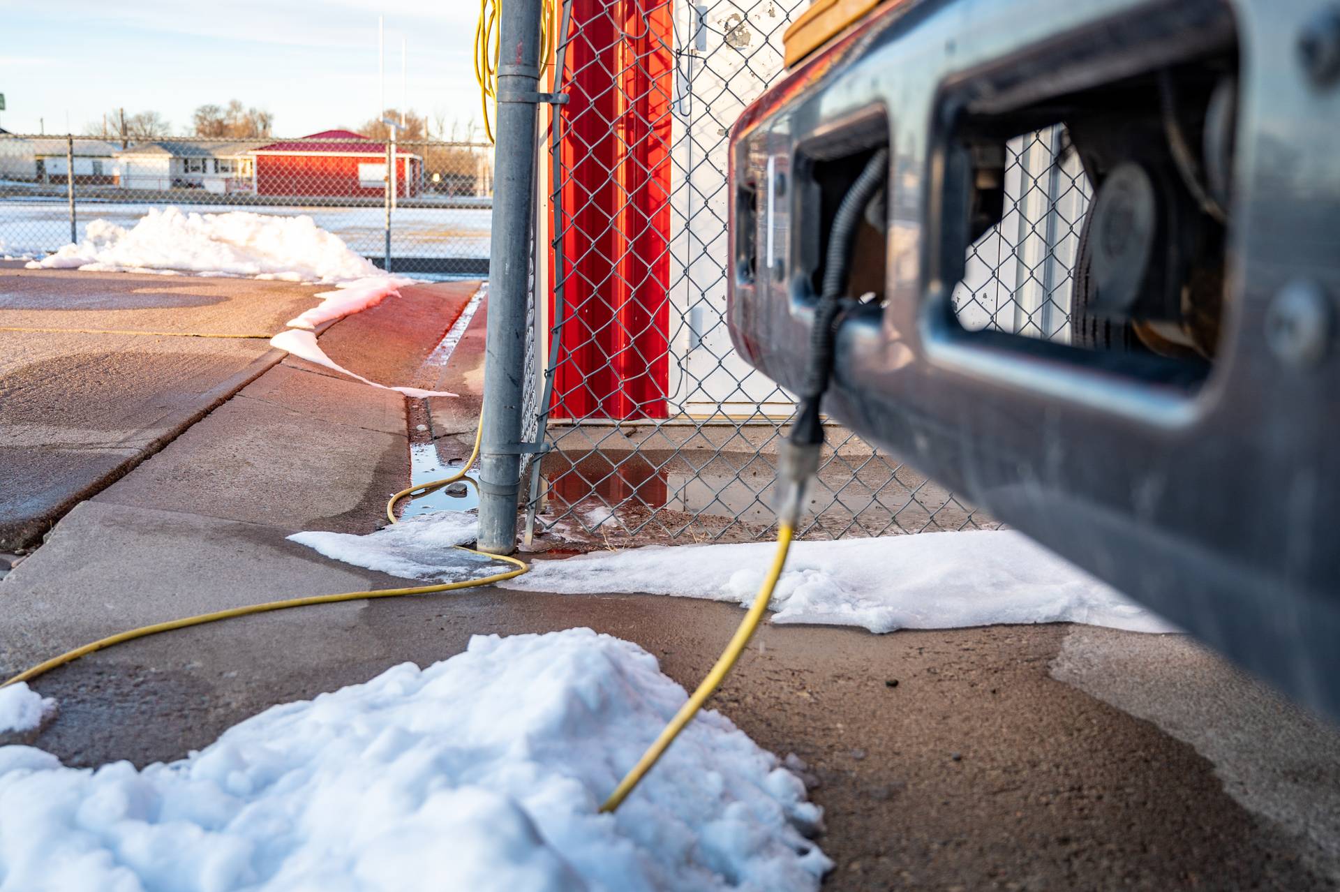 Engine block heater controller attached to a vehicle
